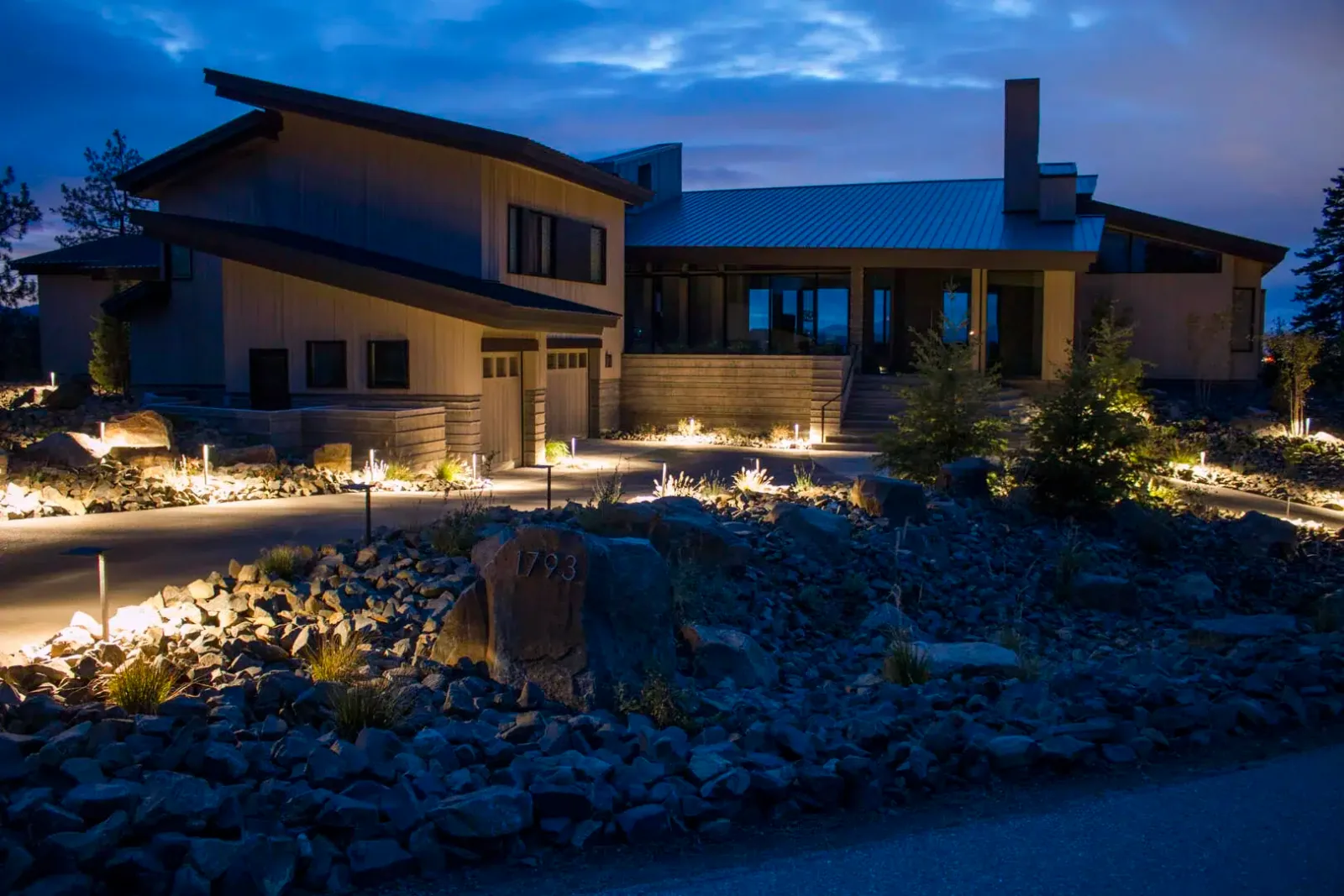 Front Yard Landscape Lighting Over Decorative Rock and Shrubs